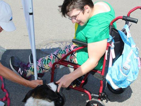 Woman with disabilities petting a dog