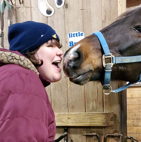 Verland Resident touching noses with a horse
